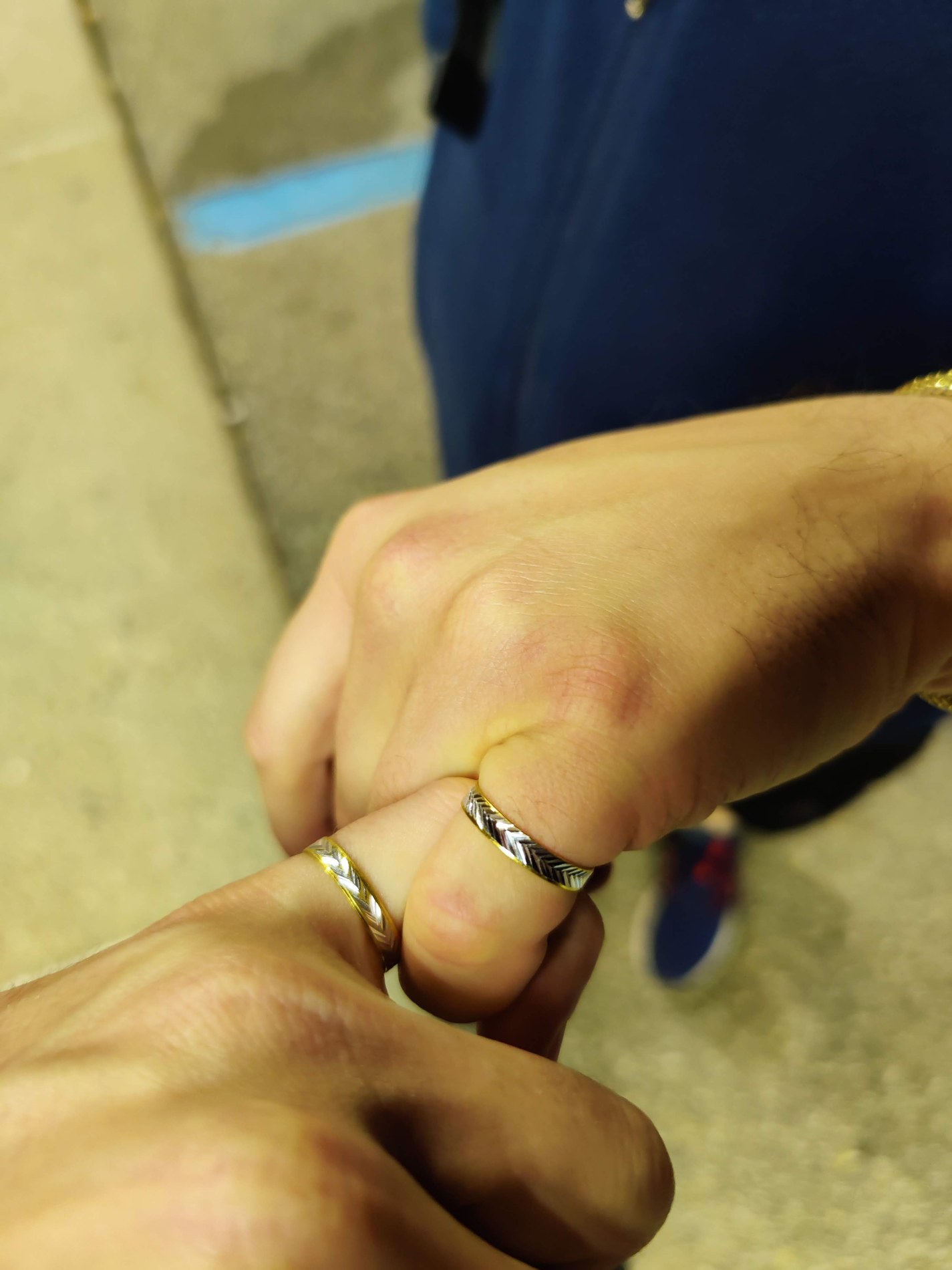 Hands touching with rings on their fingers