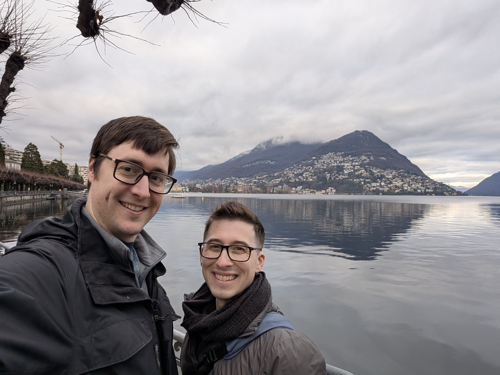 Aaron and Peter beside a lake and distant mountains